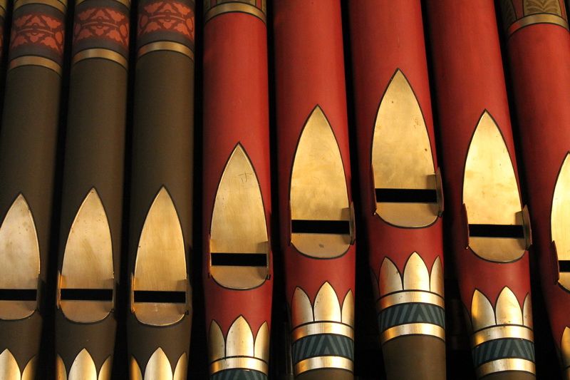 Close-up of the stencilled red, gold and olive pipes of the 1884 Johnson & Son organ.